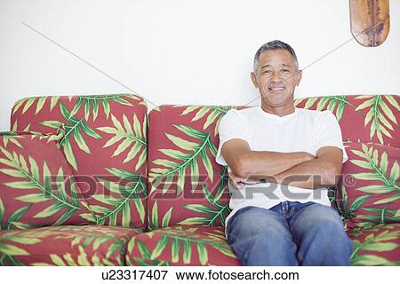 Mature man sitting on sofa View Large Photo Image Stock Photo - Mature man sitting on sofa. Fotosearch
