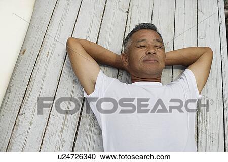 Mature man sleeping on planks View Large Photo Image Stock Image - Mature man sleeping on planks. Fotosearch