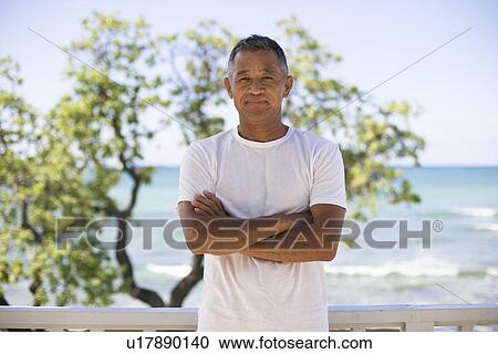 Mature man smiling with arms crossed View Large Photo Image Stock Image - Mature man smiling with arms crossed. Fotosearch