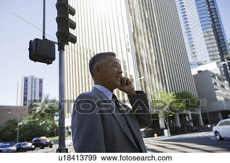 Profile of a businessman using mobile phone View Large Photo Image Stock Photo - Profile of a businessman using mobile phone. Fotosearch