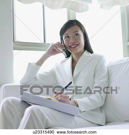 Businesswoman talking on a mobile phone View Large Photo Image Stock Image - Businesswoman talking on a mobile phone. Fotosearch