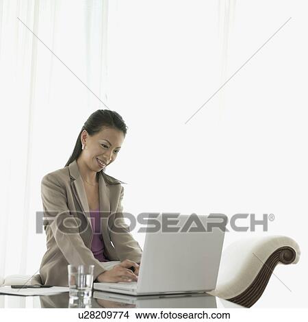 Businesswoman working on a laptop View Large Photo Image Picture - Businesswoman working on a laptop. Fotosearch