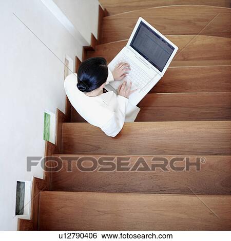 Stock Photograph - High angle view of a businesswoman using a laptop. Fotosearch