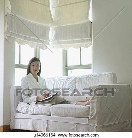 Portrait of a businesswoman relaxing on a couch View Large Photo Image Picture - Portrait of a businesswoman relaxing on a couch. Fotosearch