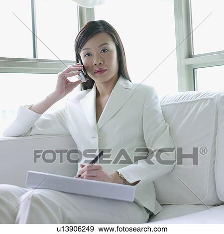 Stock Photo - Portrait of a businesswoman talking on a mobile phone. Fotosearch
