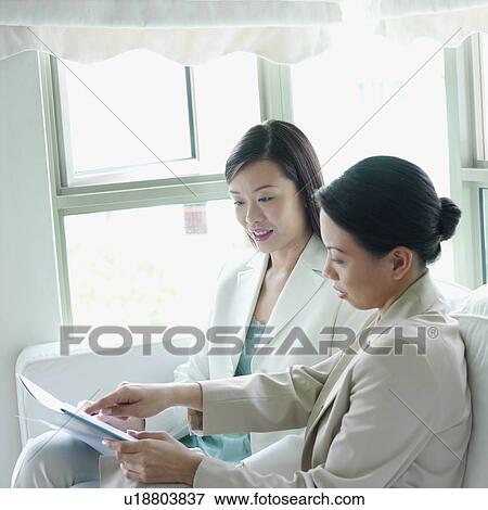 Side profile of a businesswoman discussing in an office View Large Photo Image Stock Photo - Side profile of a businesswoman discussing in an office. Fotosearch