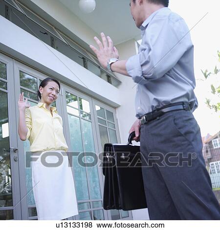 Side profile of a mid adult man waving to a young woman View Large Photo Image Stock Photo - Side profile of a mid adult man waving to a young woman. Fotosearch