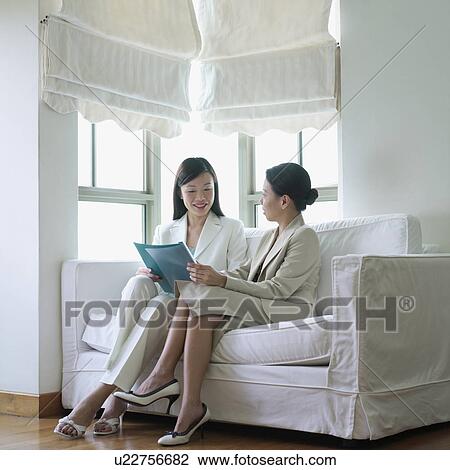 Two businesswomen talking to each other View Large Photo Image Stock Image - Two businesswomen talking to each other. Fotosearch