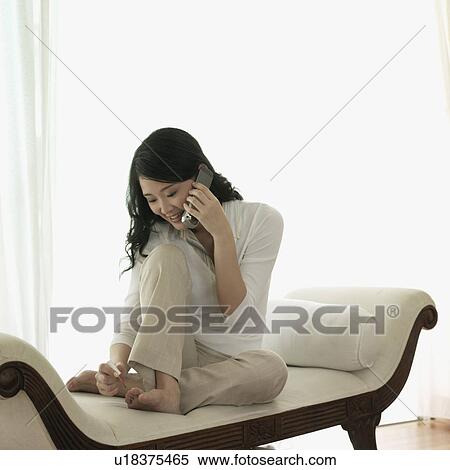 Stock Photography - Young woman talking on a mobile phone. Fotosearch
