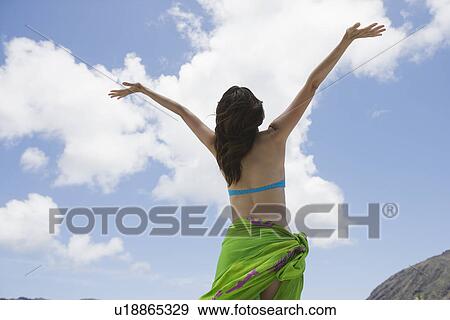 Stock Photo - Rear view of a woman with arms out. Fotosearch