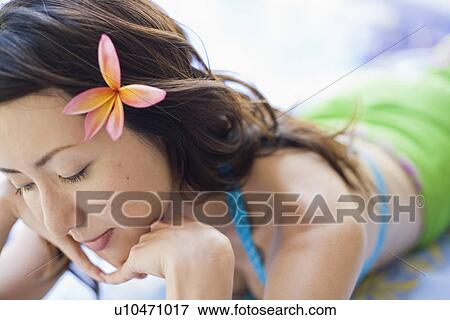 Stock Photo - View of a young woman relaxing. Fotosearch