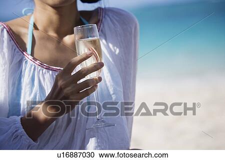 Stock Image - Close-up of a woman holding wineglass. Fotosearch
