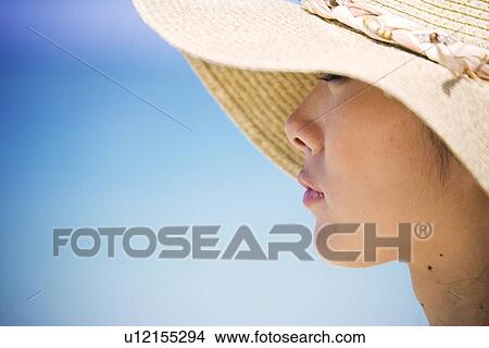 Picture - Close-up of a woman wearing hat. Fotosearch