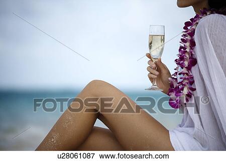 Midsection of a woman holding wineglass View Large Photo Image Stock Photo - Midsection of a woman holding wineglass. Fotosearch