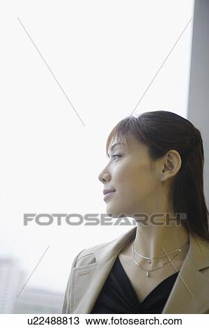 Stock Image - A side view of a woman enjoying the pleasant environment. Fotosearch