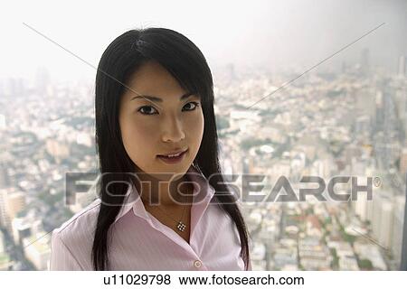 A woman stands beside a window as a landscape is seen from it View Large Photo Image Stock Photo - A woman stands beside a window as a landscape is seen from it. Fotosearch