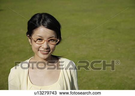 Stock Image - Portrait of a young woman smiling. Fotosearch