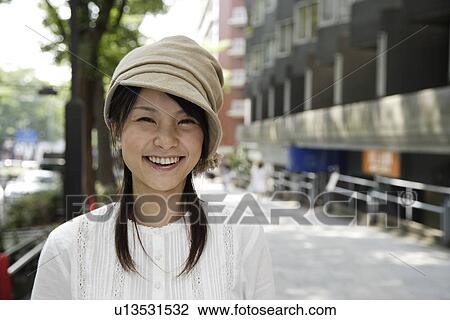 Stock Image - Portrait of a young woman smiling. Fotosearch