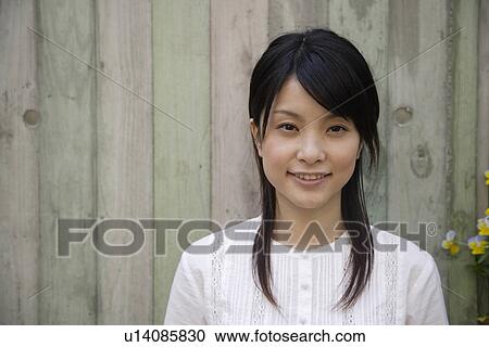 Stock Image - Portrait of a young woman smiling. Fotosearch