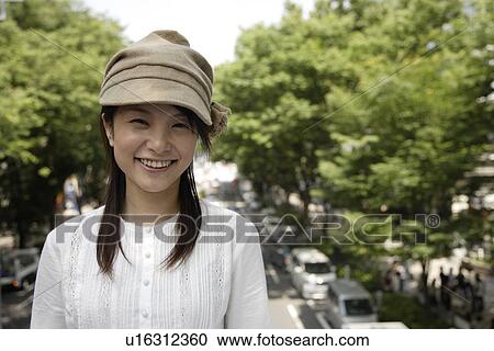 Stock Image - Portrait of a young woman smiling. Fotosearch