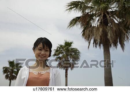 Stock Image - Portrait of a young woman smiling. Fotosearch