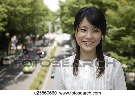 Stock Image - Portrait of a young woman smiling. Fotosearch