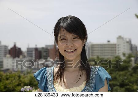 Stock Image - Portrait of a young woman smiling. Fotosearch