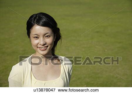 Stock Photo - Portrait of a young woman smiling. Fotosearch