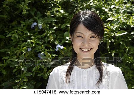 Stock Photo - Portrait of a young woman smiling. Fotosearch