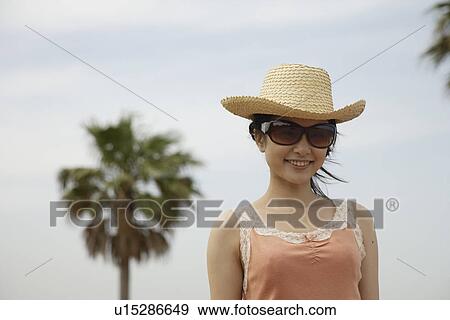 Portrait of a young woman smiling View Large Photo Image Stock Photo - Portrait of a young woman smiling. Fotosearch