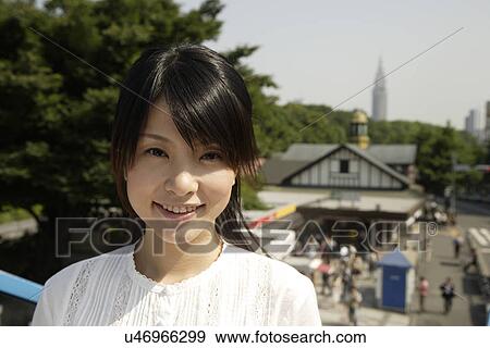 Stock Photo - Portrait of a young woman smiling. Fotosearch
