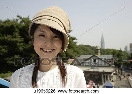 Portrait of a young woman smiling View Large Photo Image Stock Photograph - Portrait of a young woman smiling. Fotosearch