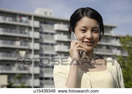Portrait of a young woman talking on mobile phone View Large Photo Image Stock Photo - Portrait of a young woman talking on mobile phone. Fotosearch