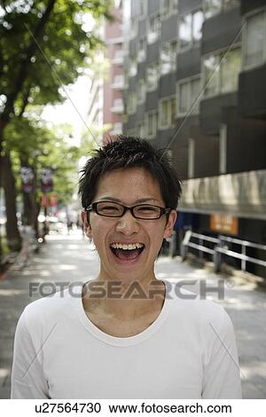 Stock Image - Portrait of a young man laughing. Fotosearch