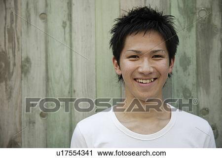 Stock Image - Portrait of a young man smiling. Fotosearch
