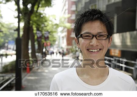 Stock Photograph - Portrait of a young man smiling. Fotosearch
