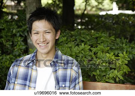 Stock Photograph - Portrait of a young man smiling. Fotosearch