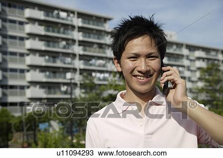 Portrait of a young man talking on mobile phone View Large Photo Image Stock Image - Portrait of a young man talking on mobile phone. Fotosearch