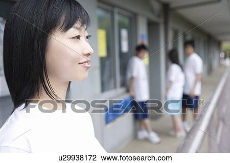 Stock Image - Four teenagers in gym clothes at outside corridor. Fotosearch