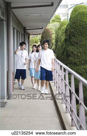 Four teenagers in gym clothes walking at outside corridor View Large Photo Image Picture - Four teenagers in gym clothes walking at outside corridor. Fotosearch