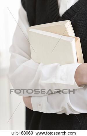Girl holding textbooks, front view, close up View Large Photo Image Stock Photo - Girl holding textbooks, front view, close up. Fotosearch