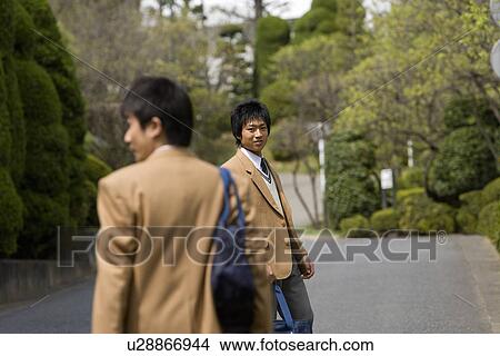 High School Boy Looking Back toward Friend, Selective Focus View Large Photo Image Picture - High School Boy Looking Back toward Friend, Selective Focus. Fotosearch