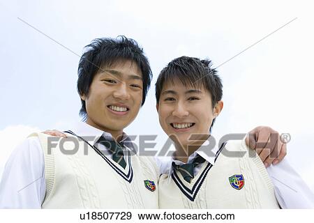 Stock Photo - High School Boys Looking at Camera, Hands on Shoulder. Fotosearch