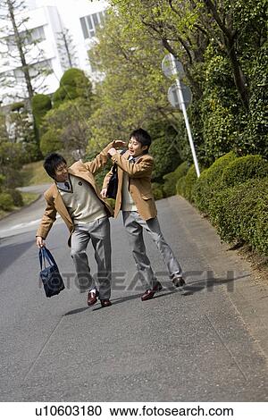 Stock Image - High School Boys Teasing Each Other. Fotosearch