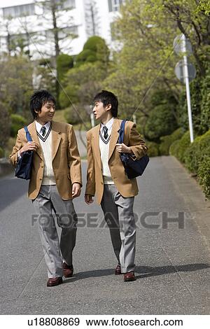 Stock Photo - High School Boys Walking on Street to Home. Fotosearch