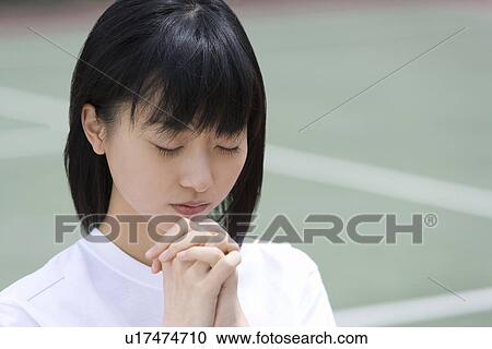 Stock Image - High School Girl Praying for Win. Fotosearch