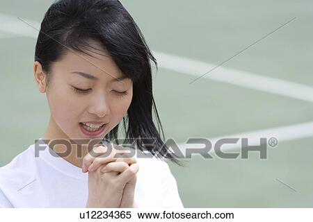 Stock Photography - High School Girl Praying for Win. Fotosearch