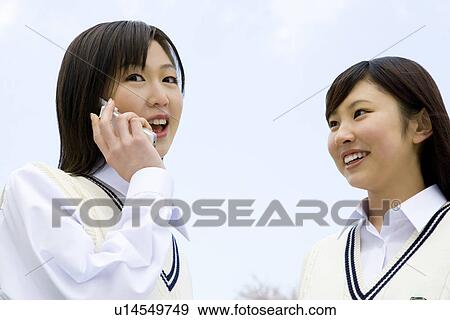 Stock Photo - High School Girl Talking on Mobile Phone in Outside. Fotosearch