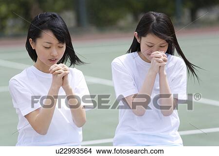 Picture - High School Girls Praying for Win. Fotosearch