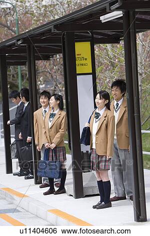Stock Photograph - High School Students Waiting at Bus Stop. Fotosearch